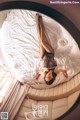 A woman laying on top of a bed in a room.