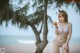 A woman in a bikini standing on a beach.