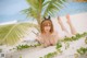 A woman in a bikini laying on the beach.