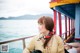 A woman sitting on a boat looking out over the water.