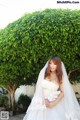 A woman in a wedding dress posing for a picture.